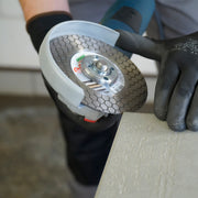 Tiler cutting porcelain tile at 45 degree bevel with DISTAR Edge Dry diamond blade