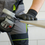 Tiler cutting porcelain tile at 45 degree bevel with DISTAR Edge Dry diamond blade