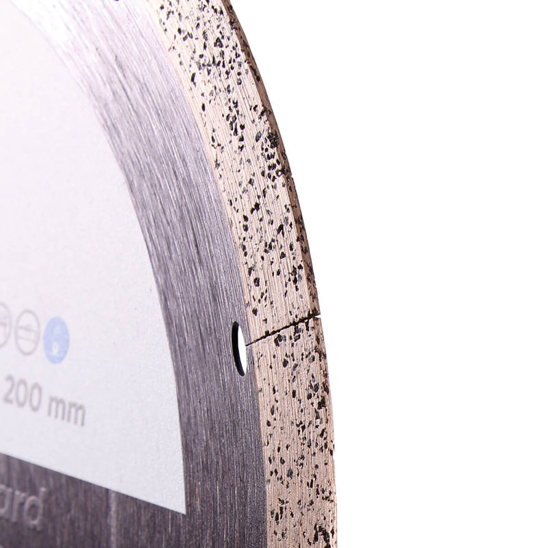 Close-up of a circular saw blade with visible teeth and specifications on a white background