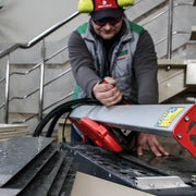 Installer cutting porcelain tile at 45 degree bevel with Edge Diamond Blade