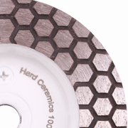Close-up of a diamond grinding wheel with honeycomb pattern on a white background