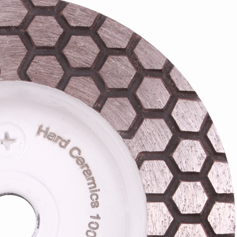 Close-up of a diamond grinding wheel with honeycomb pattern on a white background