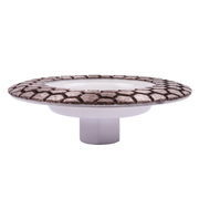 Decorative cake stand with patterned top and white base on a white background
