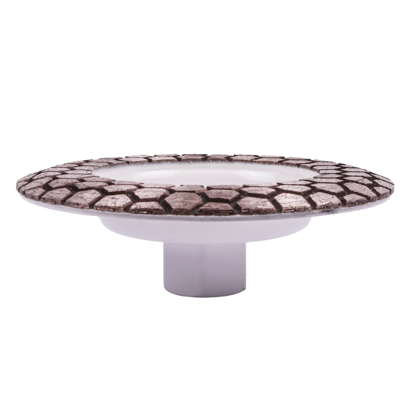 Decorative cake stand with patterned top and white base on a white background