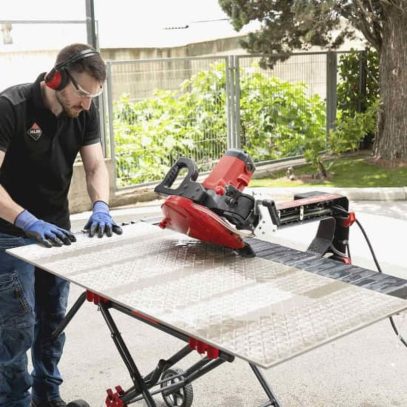 A contractor making a cut  on a large format tile with the DT-10 tile saw. Thanks to the added extension table