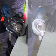 Person holding a power tool with close-up of tool head on a gray surface