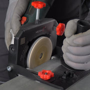 Contractor finishing ceramic tile edge with LINER on angle grinder