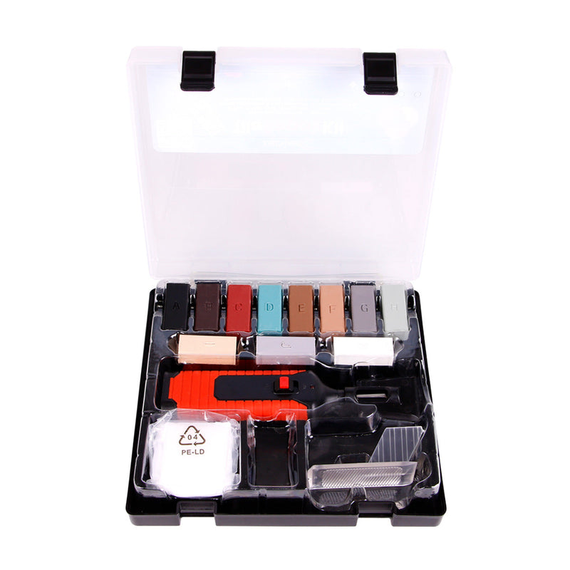 Set of makeup products including brushes and palettes in a clear case on a white background