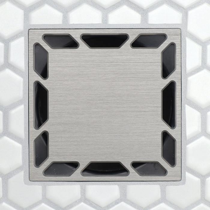 Brushed silver drain grate, square shape with corner slots and dark interior channels