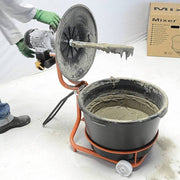 Universal mixer with black mixing tub filled with gray mortar