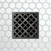 Drain grate with X-pattern metal frame and square opening tiles, brushed dark finish