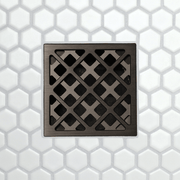 Drain grate with  chain link pattern metal frame and square opening tiles, satin bronze finish