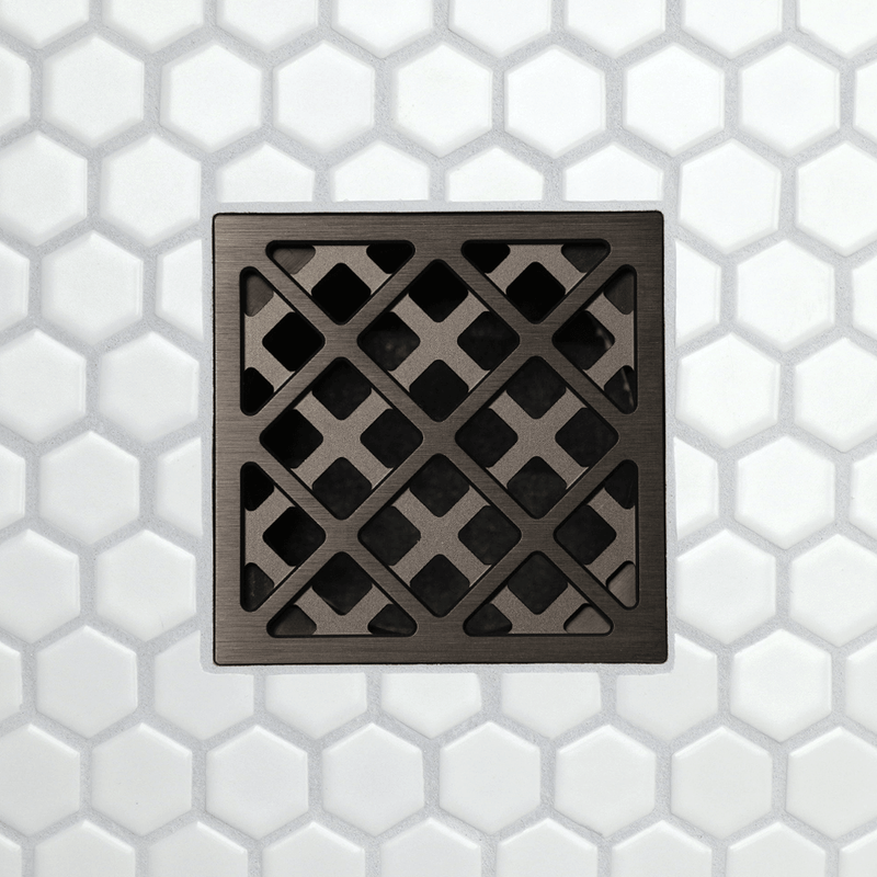 Drain grate with  chain link pattern metal frame and square opening tiles, satin bronze finish