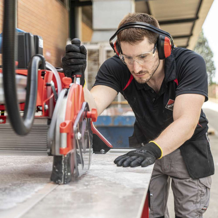 A tile contractor using the RUBI DCX-250 Xpert to make precise cuts on porcelain stoneware tiles