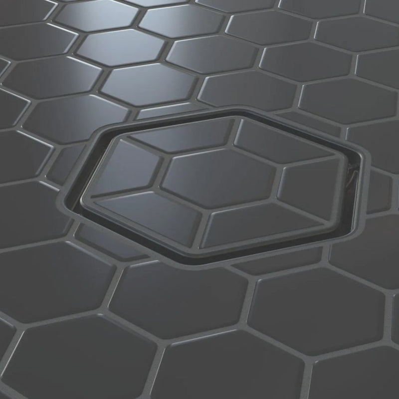 Tile-in hex drain opening with dark insert and brushed metal square frame