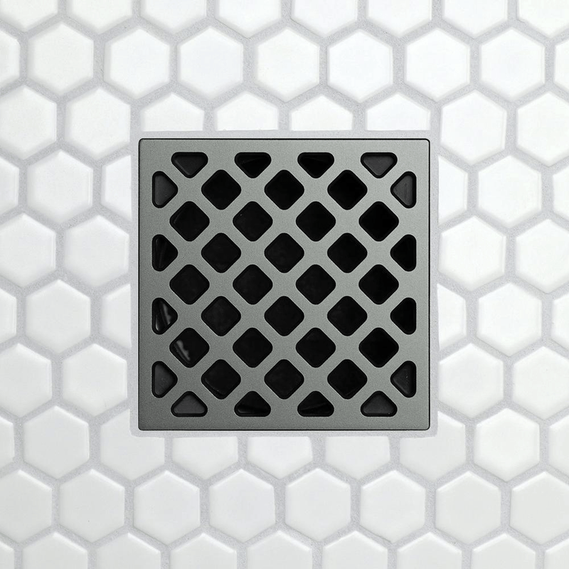 Drain grate with forty-five pattern diamond cutouts on brushed chrome finish.
