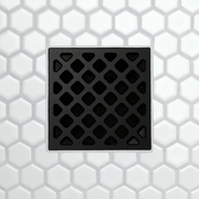 Drain grate with diamond-grid pattern, metal frame with rectangular channel slots, matte black finish