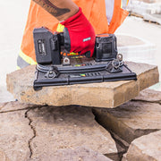 GRABO HIGH-FLOW handheld vacuum lifter gripping a porous paver