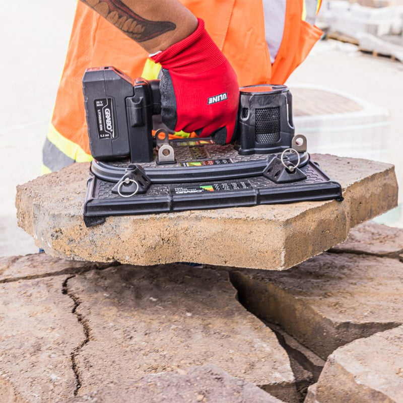 GRABO HIGH-FLOW handheld vacuum lifter gripping a porous paver