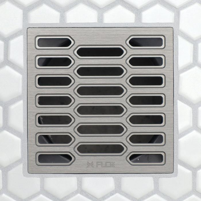 FloFX drain grate with long center slots and rounded edge openings, brushed metal finish