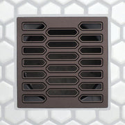 Drain grate with elongated center slots and rounded rectangular openings, bronze-toned finish