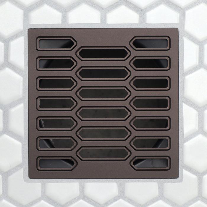 Drain grate with elongated center slots and rounded rectangular openings, bronze-toned finish