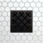 Square drain grate with 3x3 circular openings, matte black finish