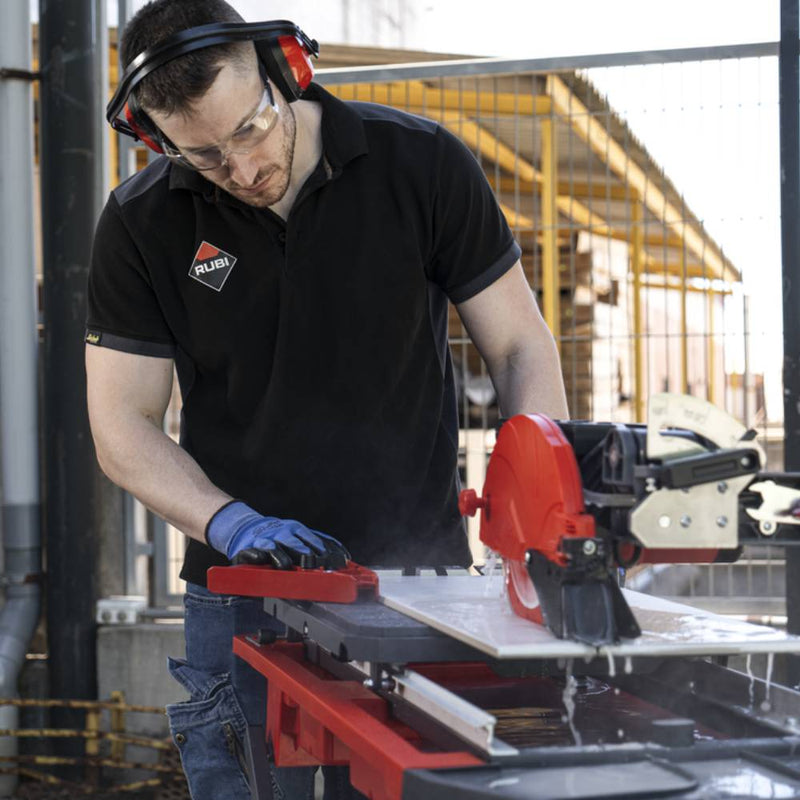 Contractor using the included guide to make precise cuts with the Rubi 7 inch tile saw