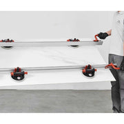 Large-format tile transport system with multiple suction cups and red grips
