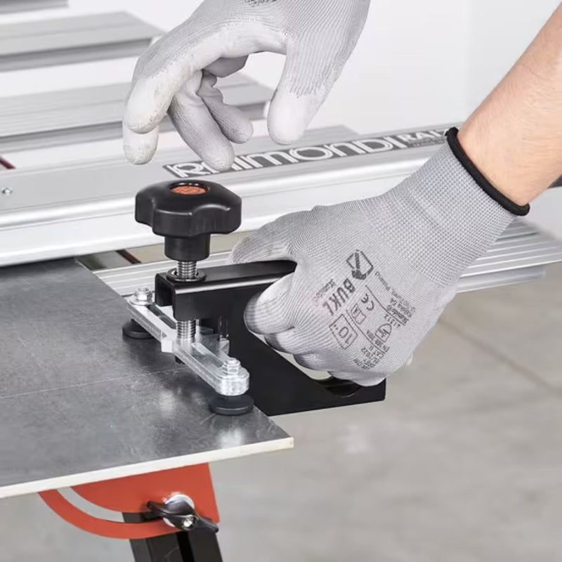 Tile cutting pliers with black knob and base, used with a gloved hand