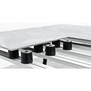 Black cylinder supports with top hole, placed along a tile leveling rail