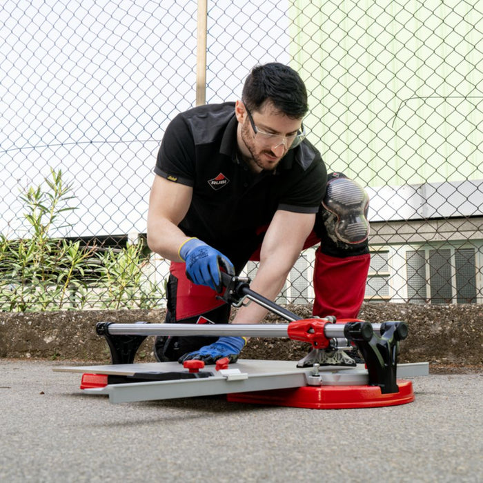 Professional tile contractor using a Rubi TX Max to cut porcelain tile on the jobsite