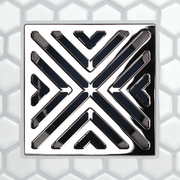 X-pattern drain grate, dark inset with chrome V-shaped grooves (FloFX)