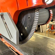Close-up of dry cut rail saw blade with circular guard and toothed rail