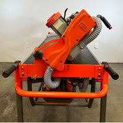 Orange dry cut rail saw front with handles and dust hose connections