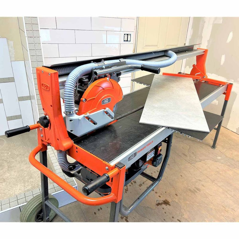 Dry cut rail saw on wheeled stand with work table and dust hoses