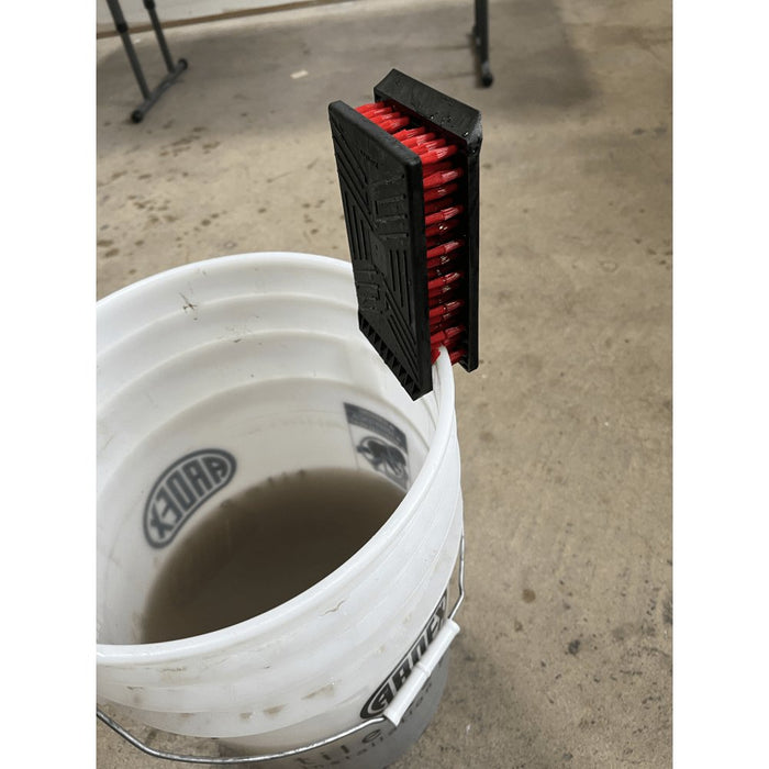 Multi-functional Trowel Brush by Russo for Cleaning and Restoration clips on the edge of the bucket to dry