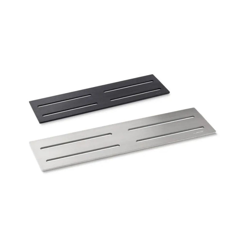 Two rectangular metal wedi shelves, one black and one silver, on a white background.